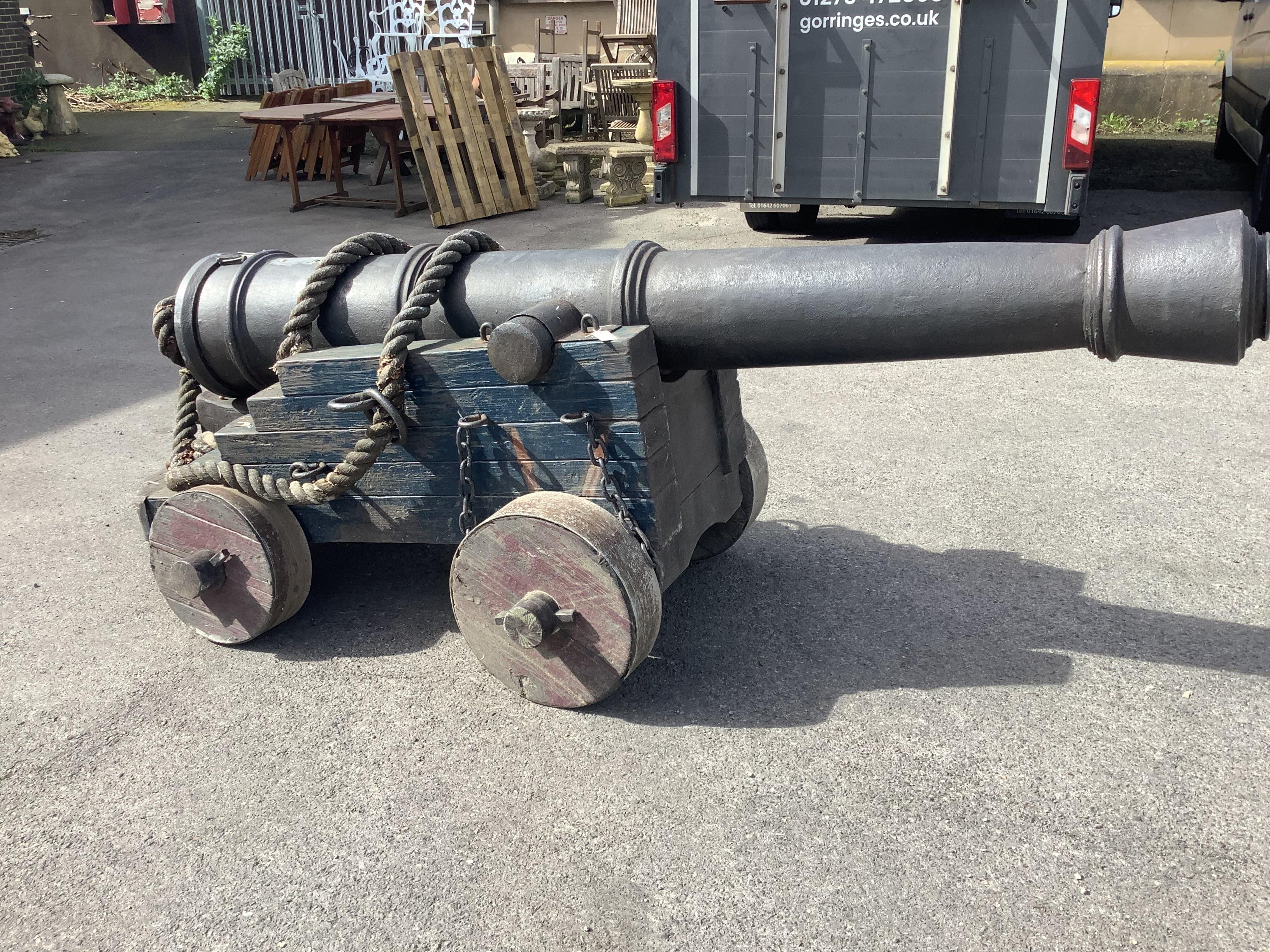 A full size iron mounted composition model of a naval cannon on wooden carriage, length 280cm